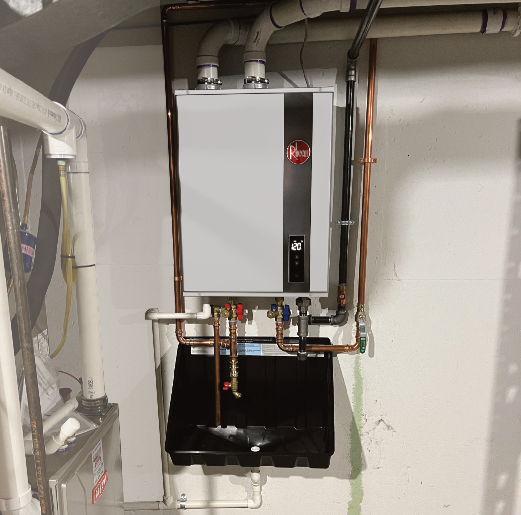 A newly installed Rheem high efficiency tankless gas water heater in a clean grand rapids basement, matching the review from Gordon Canzoneri.