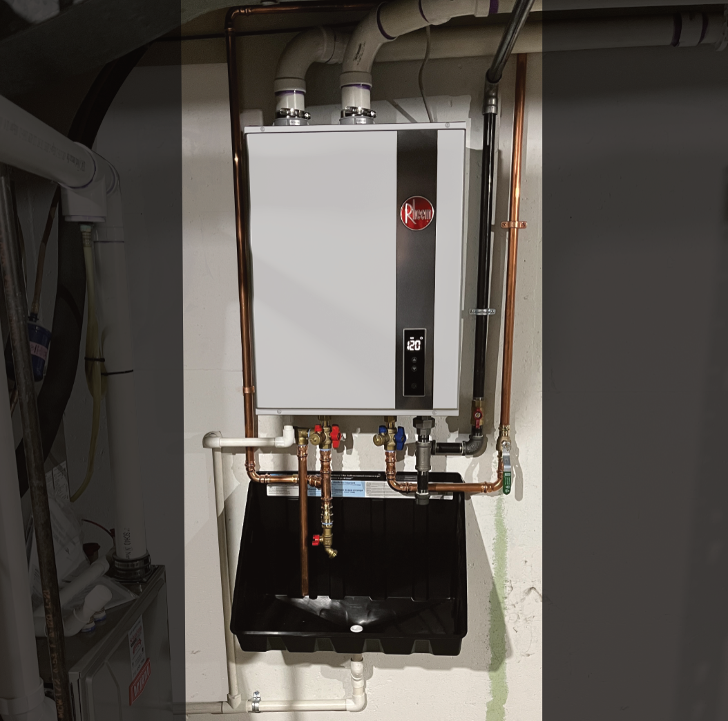 Tankless water heater installed in Grand Rapids mounted on wall with drain pan beneath it.